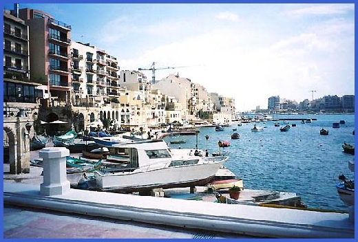 The harbour at St. Julien's Bay. Complete with couple of cranes in the background. 