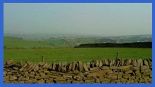 Looking from Fulwood Lane over the fields towards Sheffield which can just be seen in the distance .