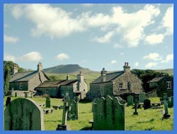 The churchyard in Horton in Ribblesdale with a view of Pen-y-ghent beyond .