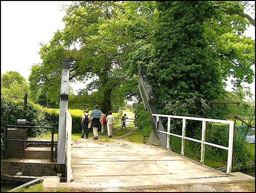 Over the canal draw bridge on the way to Drawbridge Farm .